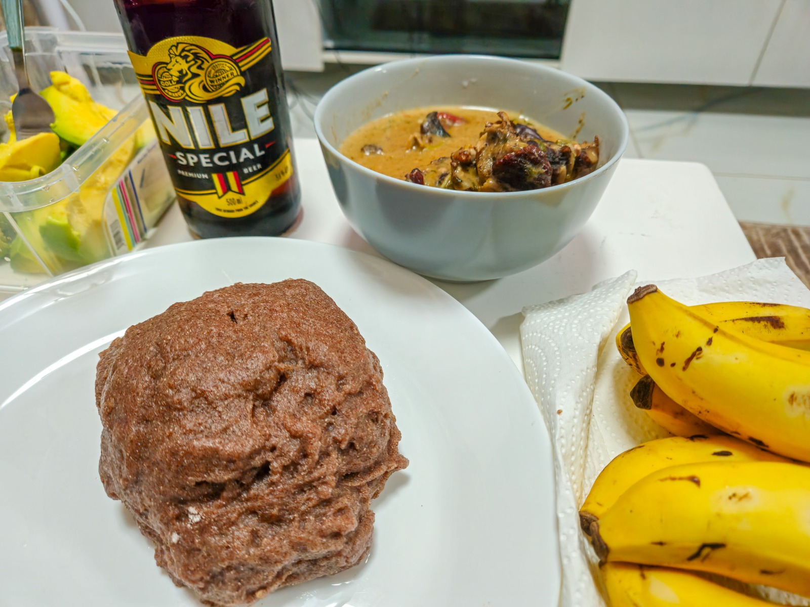 Kalo, groundnut sauce and Nile Special beer in Kampala